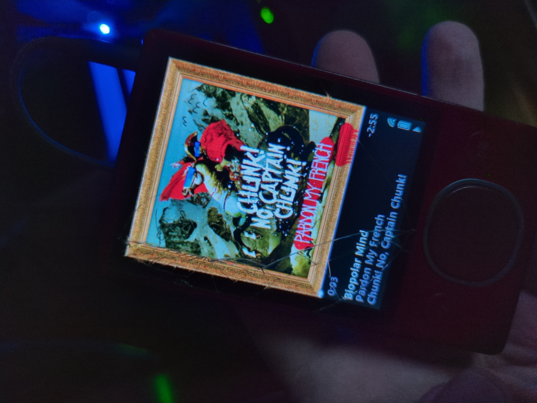 The same cracked red 120GB Zune MP3 player, displaying the band Chunk! No, Captain Chunk!'s son Bipolar Mind